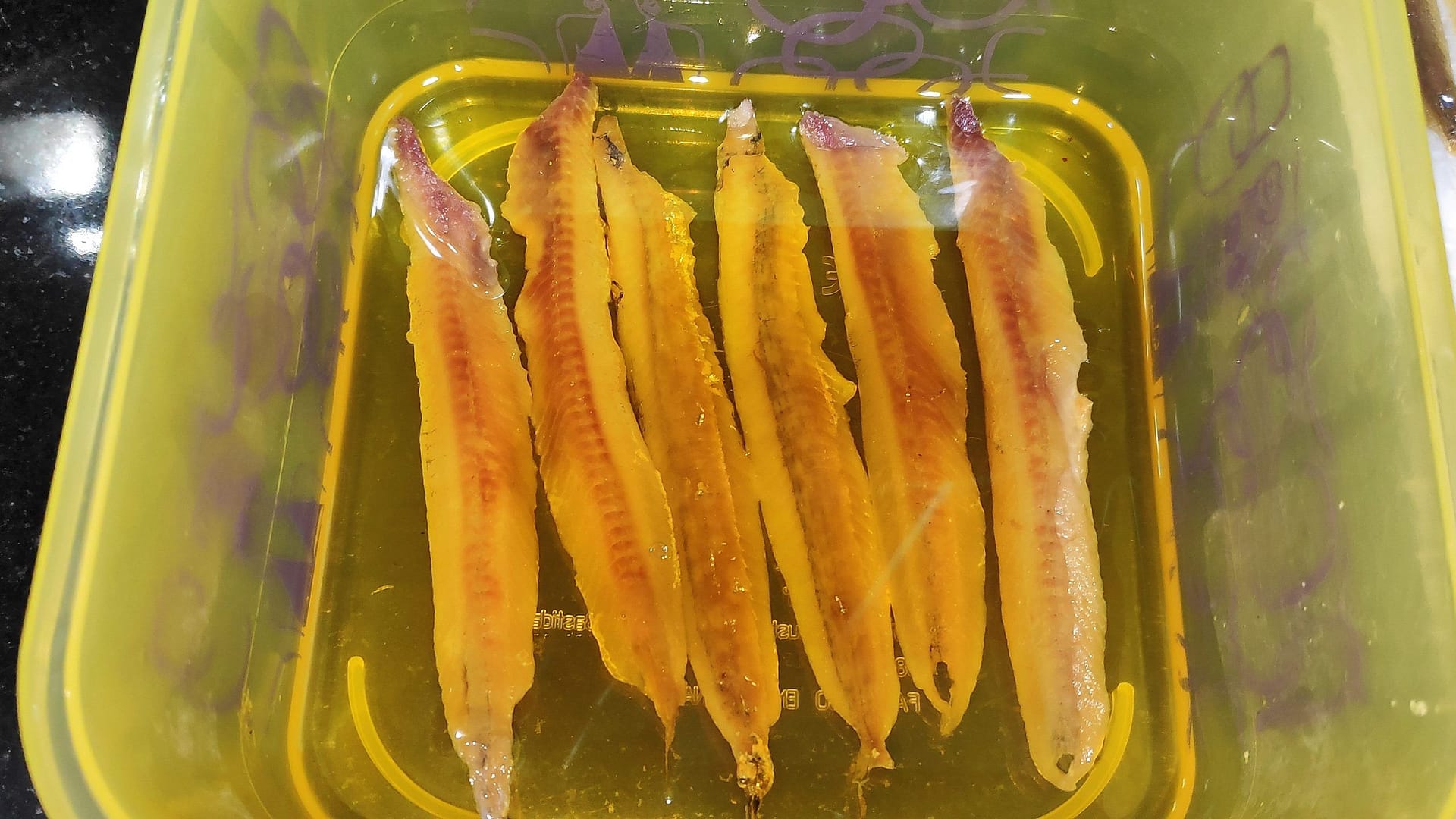 anchovies in a bowl in olive oil