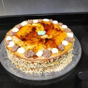 tarta de yema quemada decorada con nata,trufa y una flor