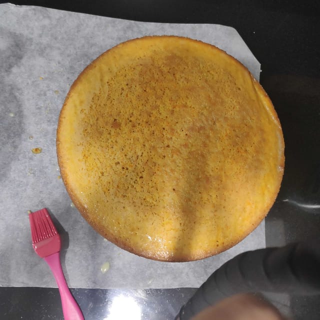 sponge cake painted with syrup and a kitchen brush