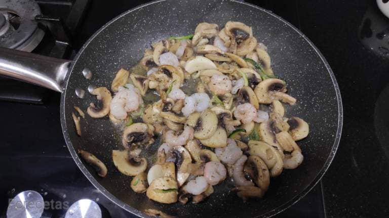 mushrooms and prawns in the frying pan to make the courgette spaghetti sauce