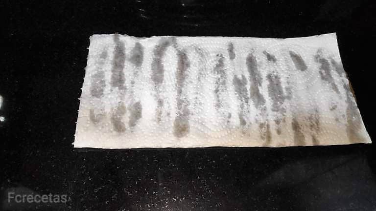 anchovies draining on absorbent paper