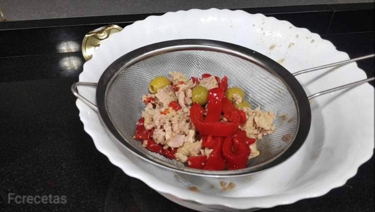 tuna, olives and pepper in a colander